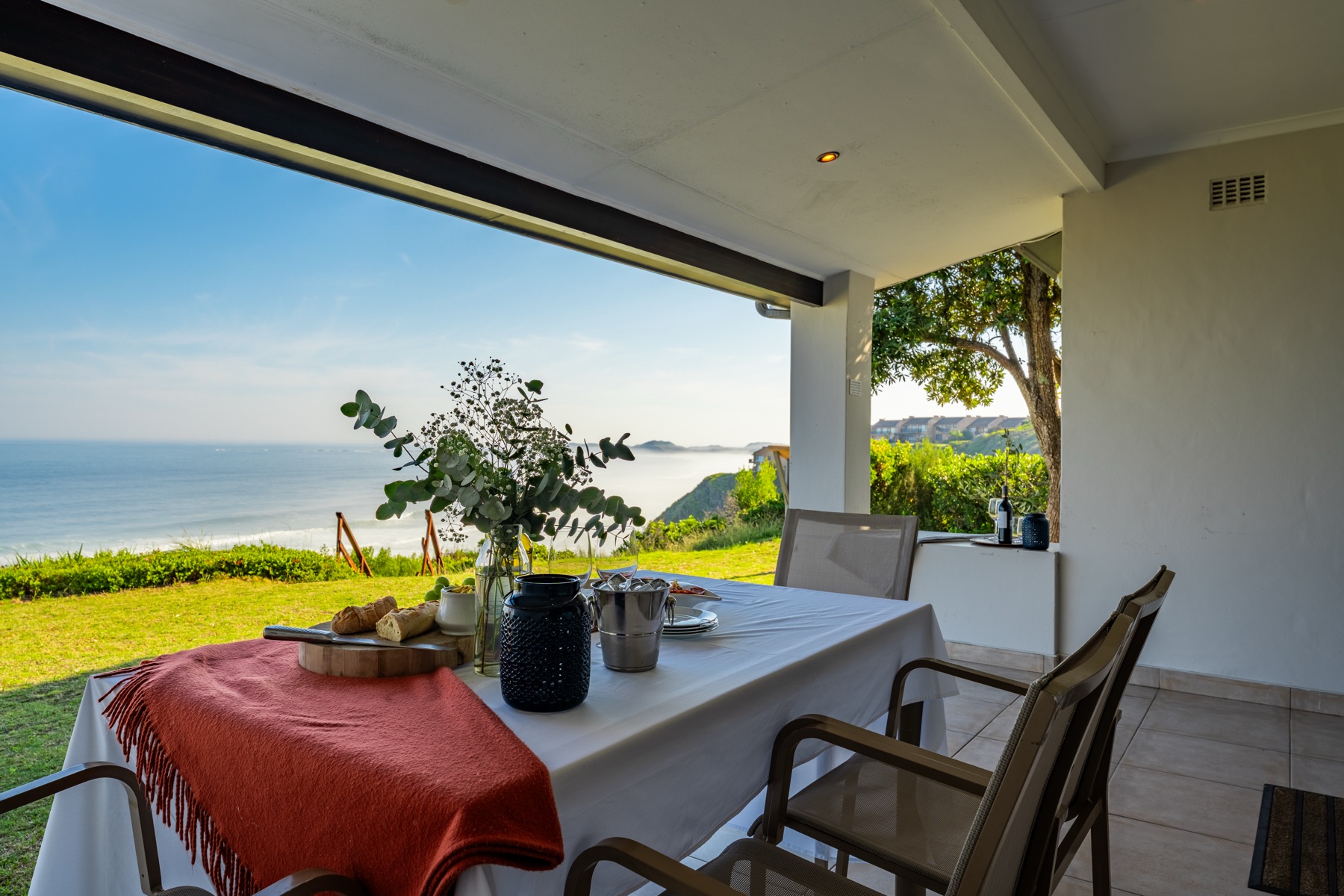 Sea-view patio with dining table real estate photography — Knysna