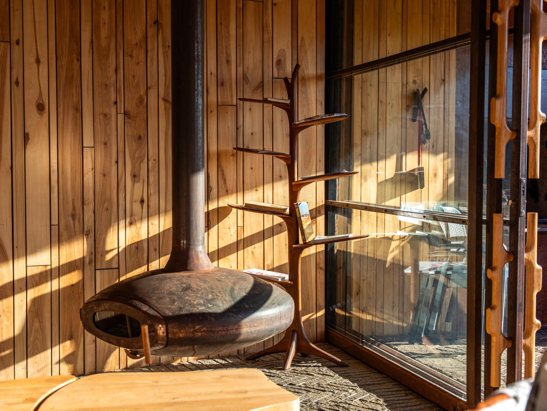 Suspended fireplace and timber interior — lodge photography