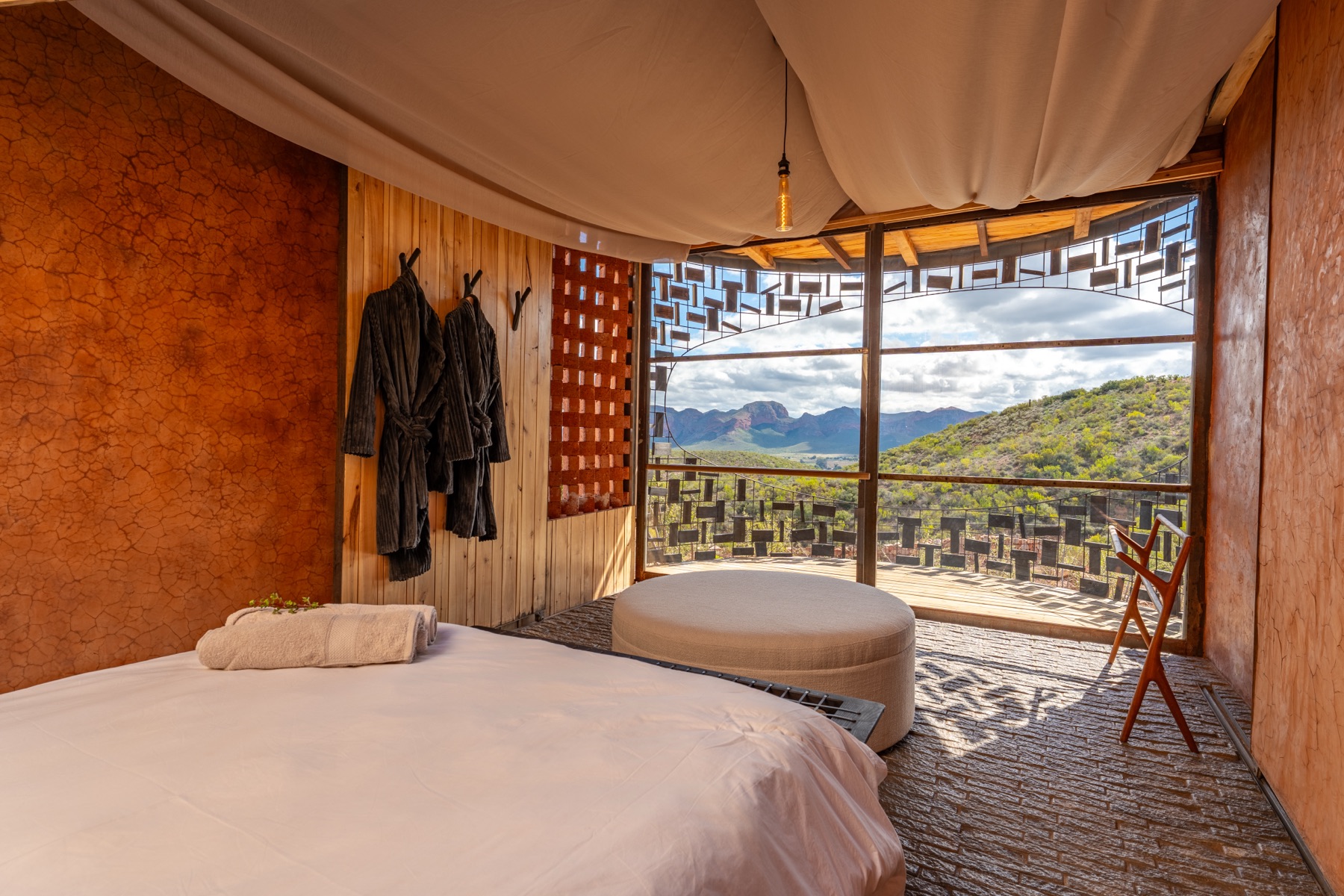 Lodge suite bedroom with a mountain view — hospitality photography